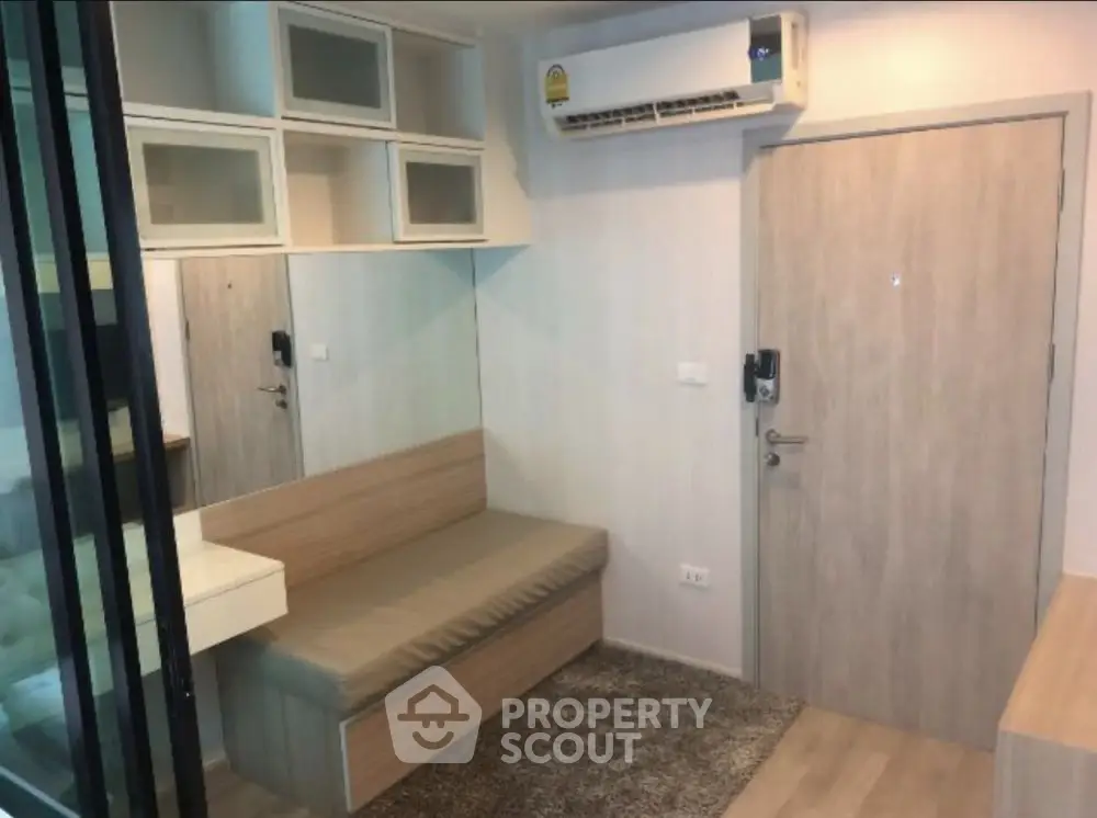 Cozy small living area with built-in seating and air conditioning