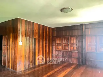 Spacious wooden interior with rich wood paneling and natural light