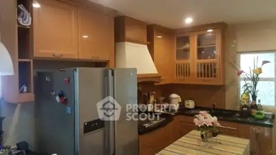 Charming kitchen with wooden cabinets and modern appliances, perfect for culinary enthusiasts.