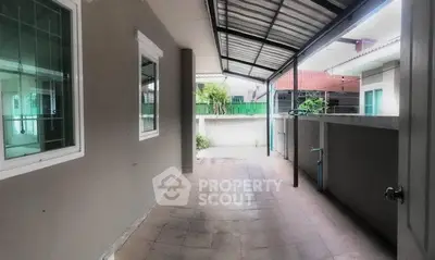 Spacious covered outdoor area with tiled flooring and modern design.