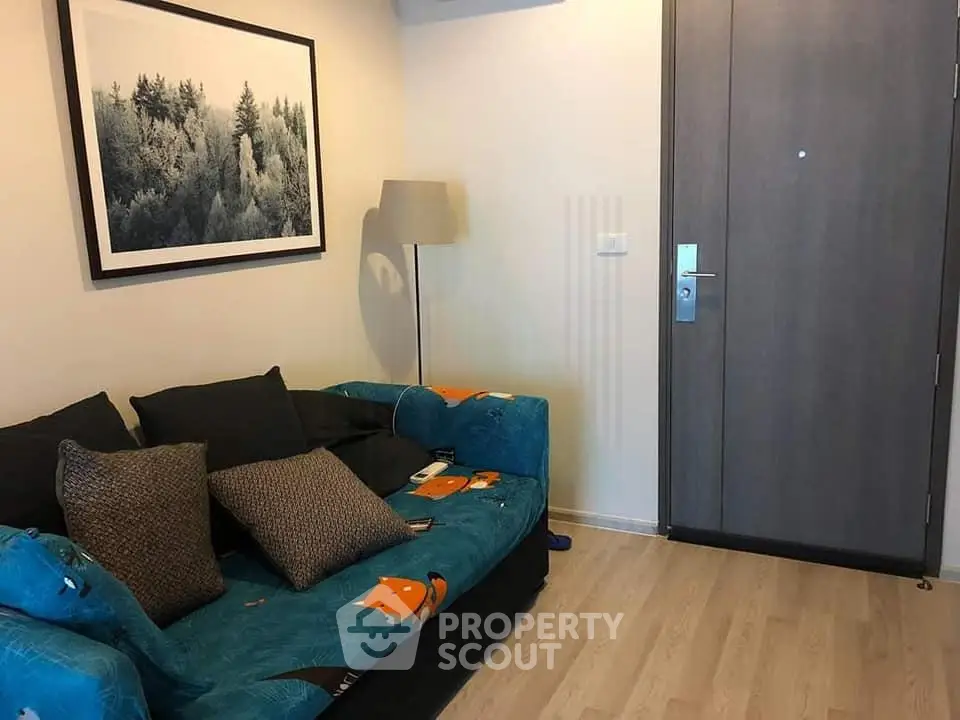 Cozy living room with modern decor and comfortable seating in a stylish apartment.