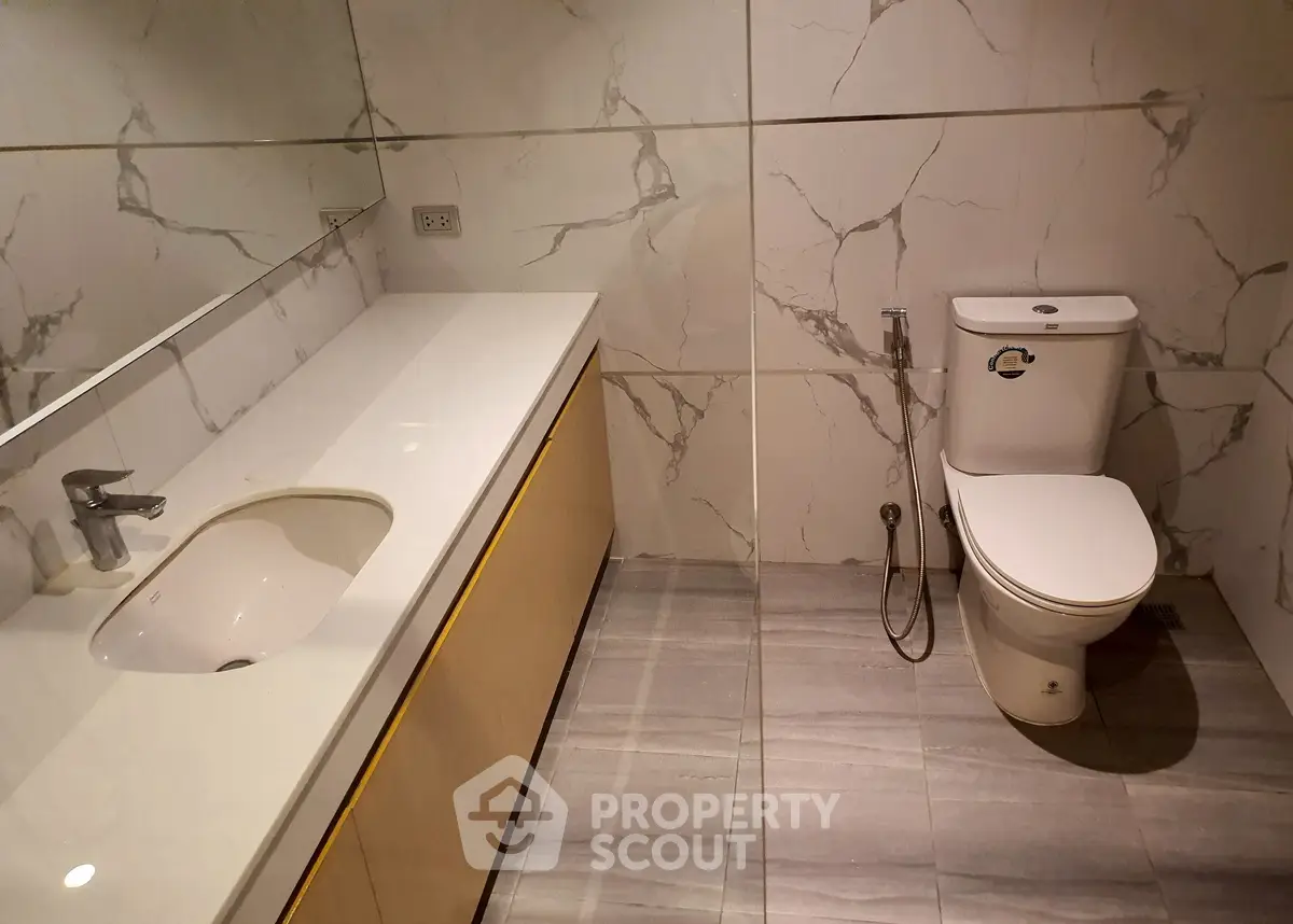 Modern bathroom with sleek marble tiles and elegant fixtures
