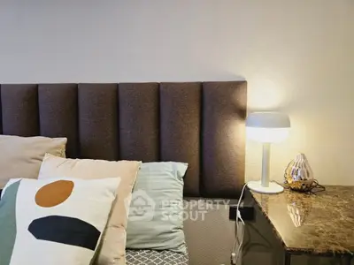 Cozy bedroom corner with modern lamp and stylish headboard