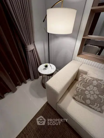 Cozy modern living room corner with elegant lighting and plush sofa