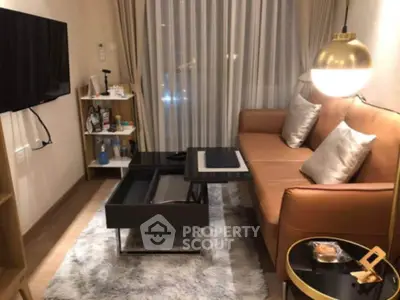 Cozy modern living room with stylish sofa, elegant lighting, and sleek TV setup.