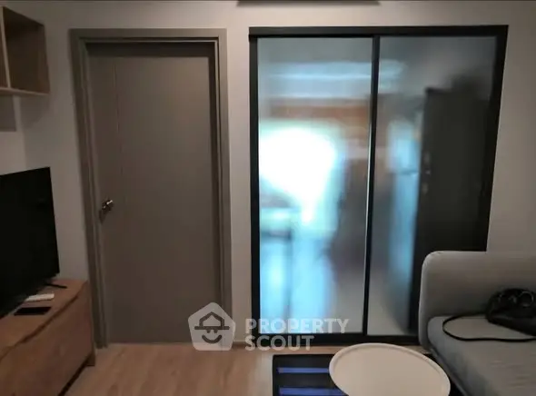 Modern living room with frosted glass sliding doors and cozy seating area.