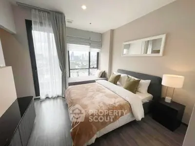 Modern bedroom with city view, featuring cozy bed and stylish decor in a high-rise apartment.