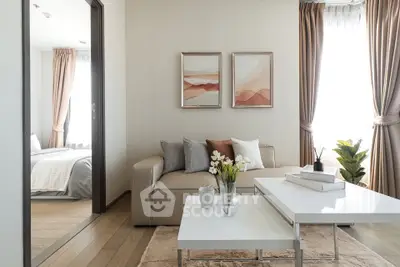 Modern living room with elegant decor and natural light, featuring a cozy sofa and stylish coffee table.