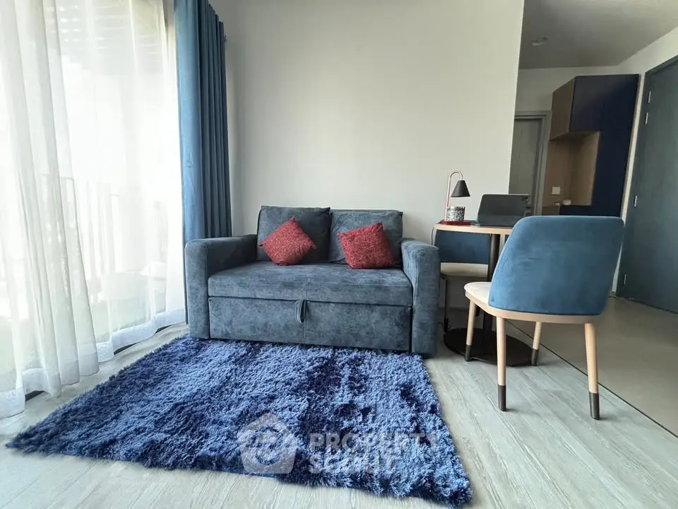 Modern living room with stylish blue sofa and cozy decor