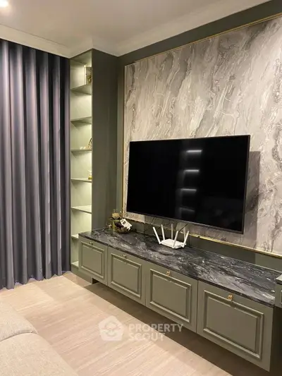 Elegant living room with modern TV setup and stylish marble accent wall