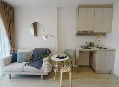 Modern compact living room with cozy sofa and stylish kitchenette