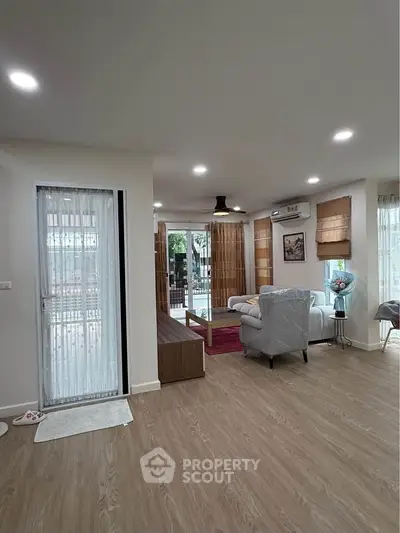 Spacious living room with modern decor and large windows for natural light.