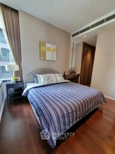 Luxurious bedroom with elegant decor and hardwood floors in modern apartment