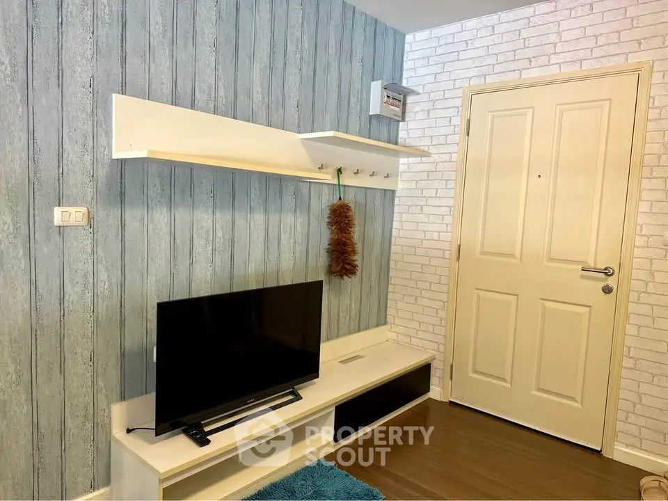 Cozy living room with modern TV setup and stylish wall decor