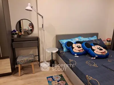 Charming bedroom with stylish decor and playful Mickey Mouse pillows, perfect for a cozy retreat.