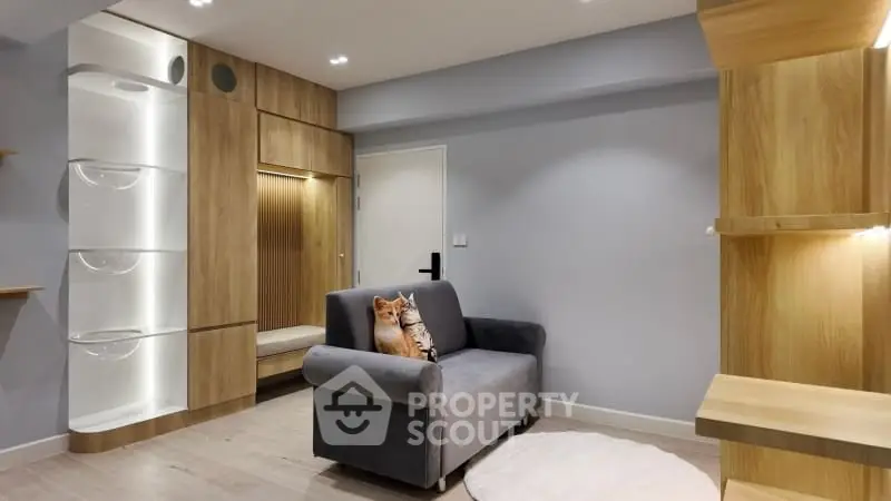 Modern living room with sleek wooden cabinetry and cozy gray sofa
