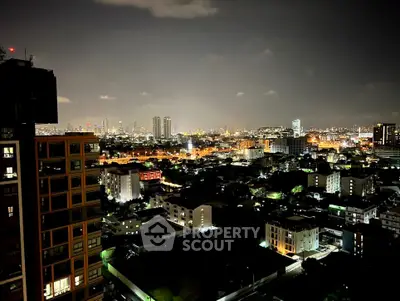 Stunning night cityscape view from high-rise building, showcasing vibrant urban lights and skyline.