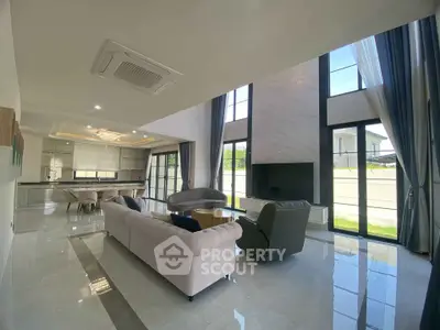 Luxurious open-plan living room with high ceilings and modern decor
