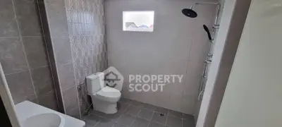 Modern bathroom with sleek tiles and rainfall showerhead
