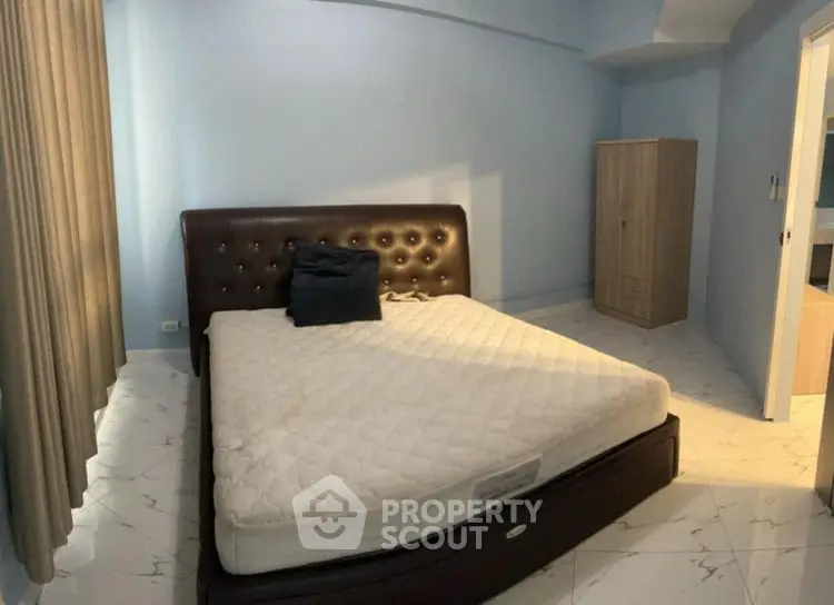 Spacious bedroom with modern bed and wardrobe, ideal for comfort and style.
