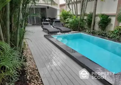 Luxurious backyard with private pool and lush greenery, perfect for relaxation.