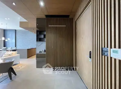 Modern living room with stylish wooden paneling and open kitchen layout