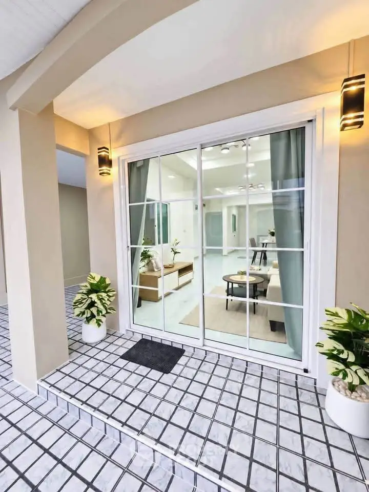 Elegant entrance with modern sliding glass doors and stylish interior view.
