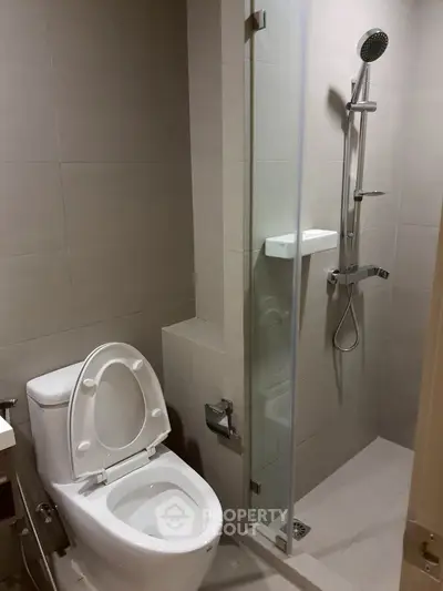 Modern bathroom with sleek shower and toilet in neutral tones