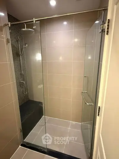 Modern bathroom with glass shower enclosure and sleek tile design