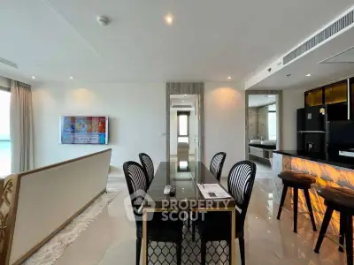 Luxurious modern living room with open kitchen and elegant dining area.