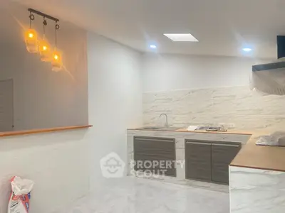 Modern kitchen with sleek cabinets and stylish lighting