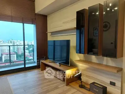 Modern living room with city view, featuring sleek TV setup and stylish wooden decor.