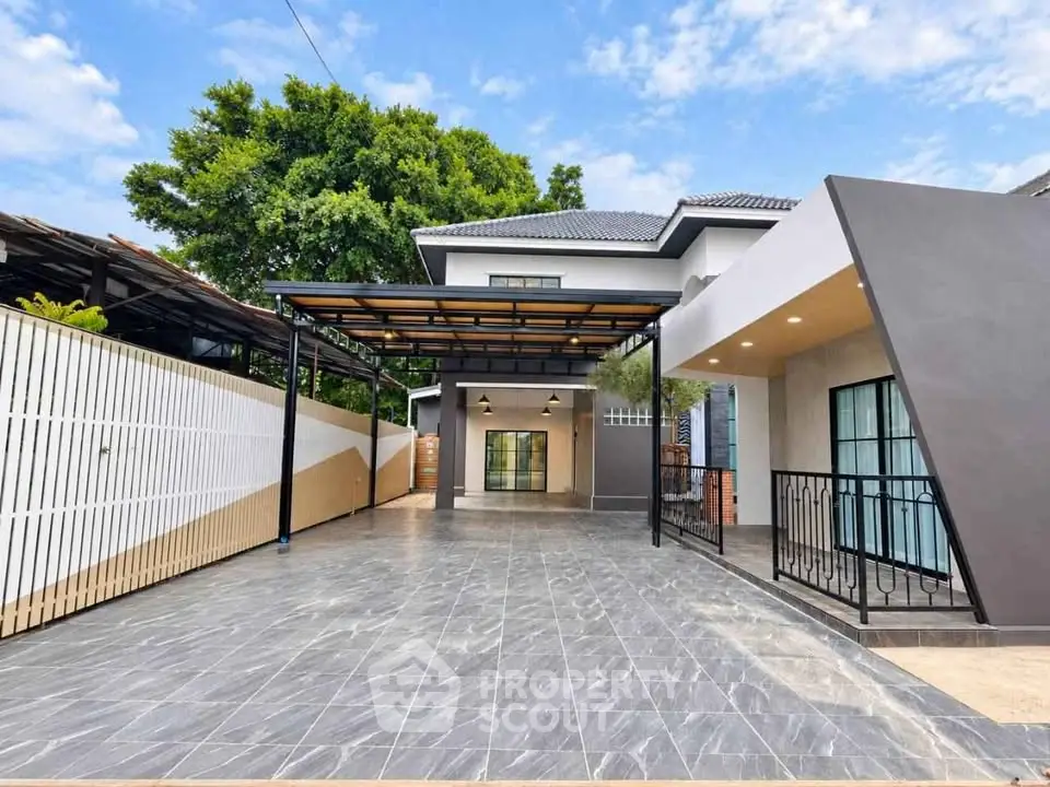 Modern two-story house with spacious driveway and sleek exterior design.