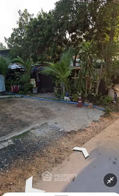 Charming rustic exterior with lush greenery and spacious outdoor area, perfect for nature lovers.