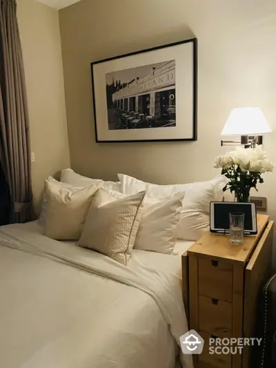 Cozy bedroom with elegant decor and soft lighting, featuring a comfortable bed and stylish artwork.