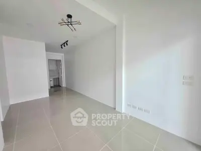 Spacious modern interior with sleek lighting and tiled flooring