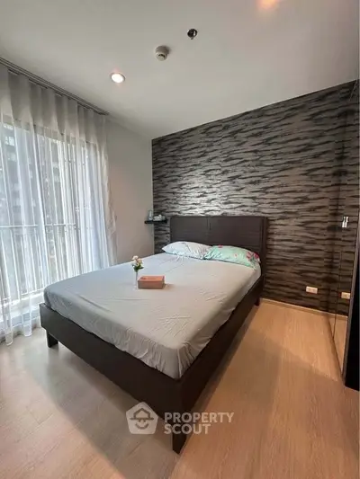 Modern bedroom with stylish accent wall and natural light