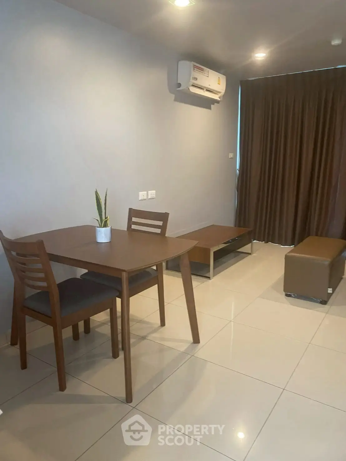 Modern living room with sleek furniture and air conditioning, perfect for comfortable living.
