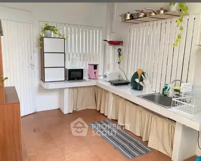 Charming kitchen with open layout, featuring modern appliances and ample storage, perfect for culinary enthusiasts.