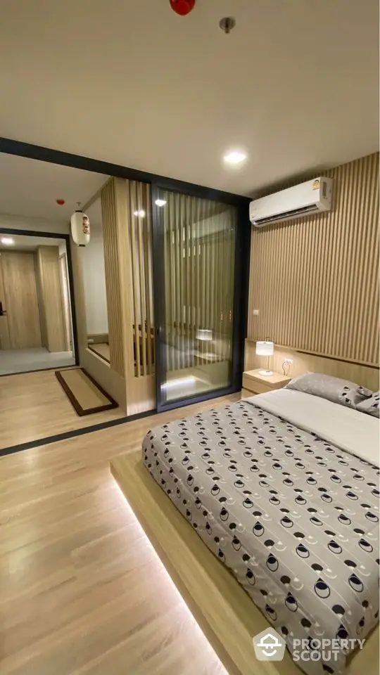 Modern bedroom with stylish decor and wooden accents in a luxury apartment.