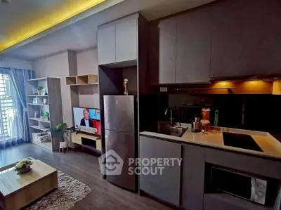 Modern open-layout kitchen and living room with sleek design and natural light.