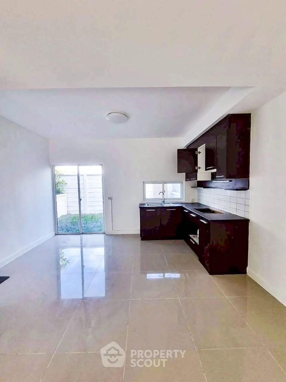 Modern kitchen with sleek cabinetry and open layout in a bright, spacious room.