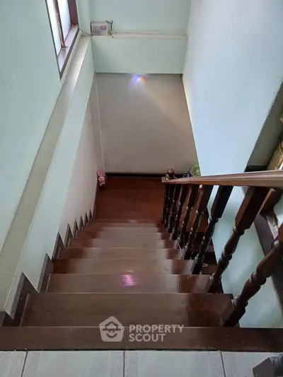 Wooden staircase with natural light in cozy home interior