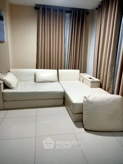 Cozy living room with modern white sectional sofa and elegant curtains
