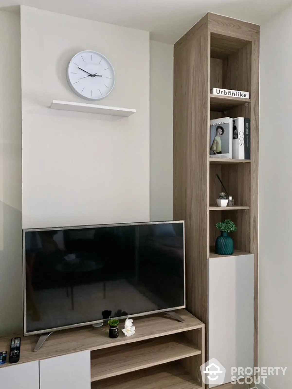 Modern living room with sleek TV setup and stylish shelving unit