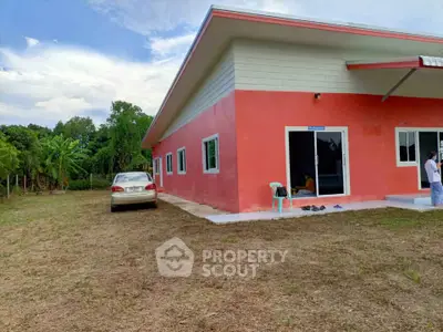 Charming single-story red house with spacious yard and modern design