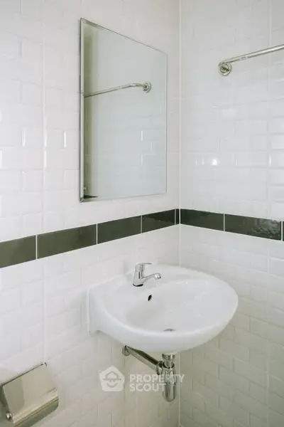 Modern bathroom with white tiles and sleek sink design
