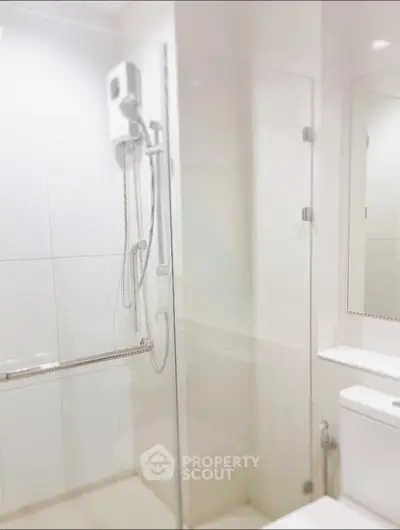 Modern bathroom with glass shower enclosure and sleek fixtures