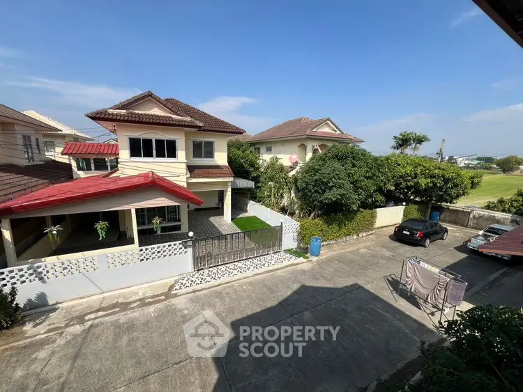 Charming suburban homes with lush greenery and spacious driveways in a peaceful neighborhood.