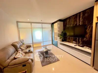 Modern living room with sleek design, cozy seating, and stylish entertainment center.